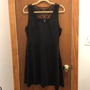 Sleeveless black dress with embroidered back